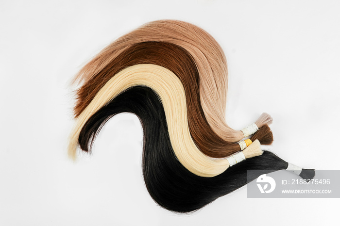 Curved hair samples for extension rolled up,different colors.White background.