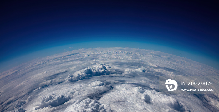 Planet Earth Curvature. Aerial shot. Blue sky and heavy clouds