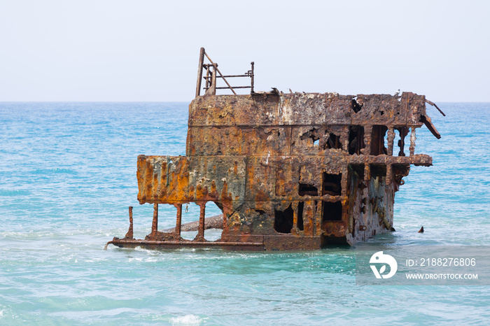 Rusty ship wreck remains surrounded by water near to Cyprus shores.