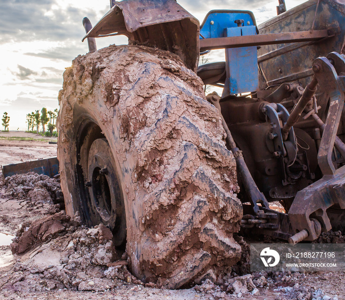 The image of the tractor in the mud