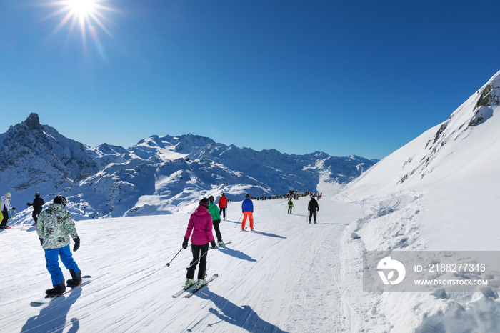 people on sunny slope at 3 valleys ski resort in Alps, France