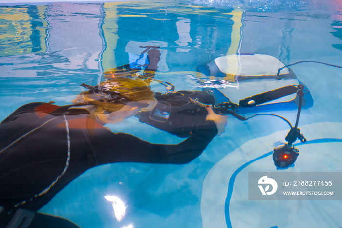 Underwater camera. Diver holds a camera for filming underwater