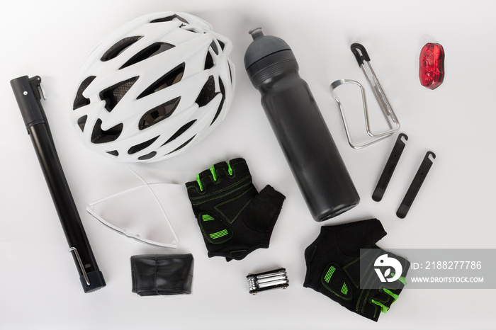 Bike accessories, bike helmet, bike gloves, eyeglasses and water bottle in holder