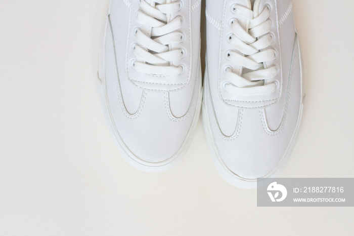 pair of white sneackers  on white background. close up