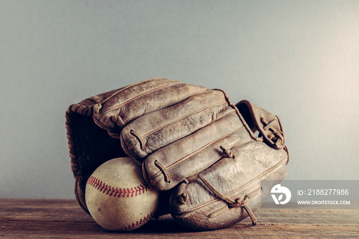 old Baseball and glove on wood background with filter effect retro vintage style