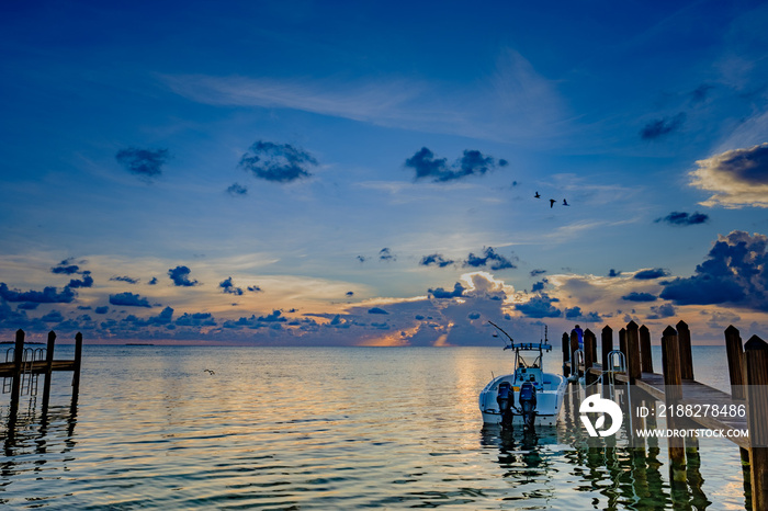 Sunbeams strike the ocean water off in the distance as the sun sets in the Florida Keys