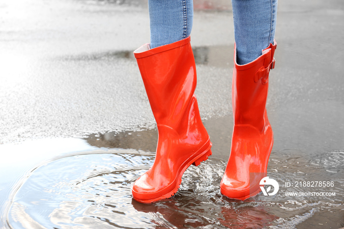 Woman in red rubber boots, outdoors