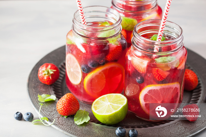 summer berry lemonade with lime and mint in mason jar