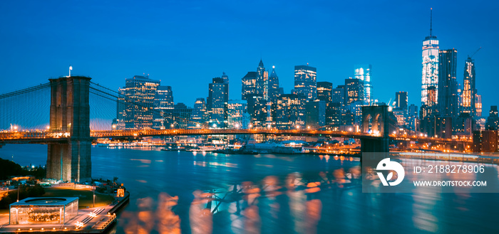 New York City at dusk with Brooklyn Bridge.