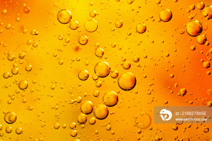 oil drops on water on an orange background