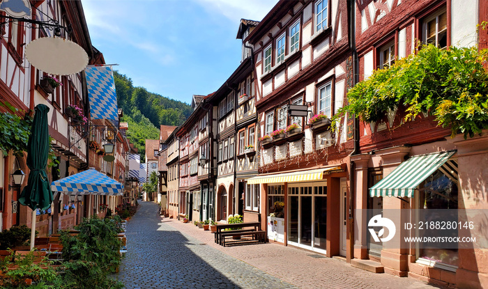 Beautiful restaurant lined street of traditional half timbered buildings in the town of Miltenberg, Bavaria, Germany