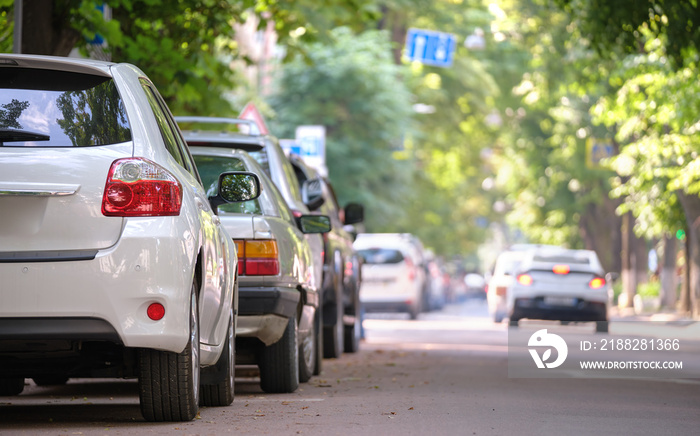 City traffic with cars parked in line on street side