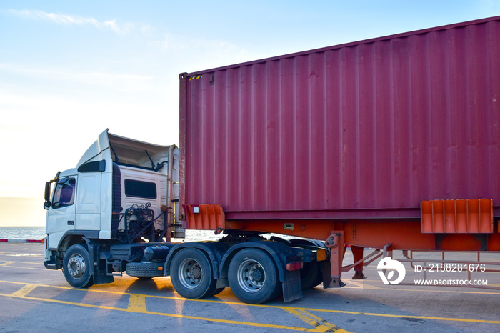 Heavy duty truck pick up shipping container at port. Logistics concept