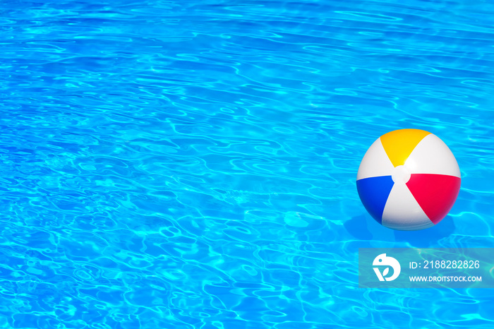 Colorful inflatable ball floating in swimming pool