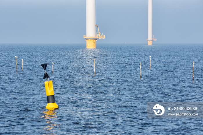 Offshore wind turbines near Dutch coast with buoy