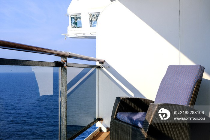 Modern balcony deck chairs sun loungers with table on balcony patio terrace veranda stateroom cabin suite terrace on ocean liner cruiseship cruise ship at sea with beautiful ocean views