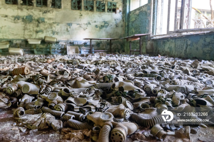 Hundreds of gas masks on school classroom floor in abandoned school in Chernobyl, Ukraine