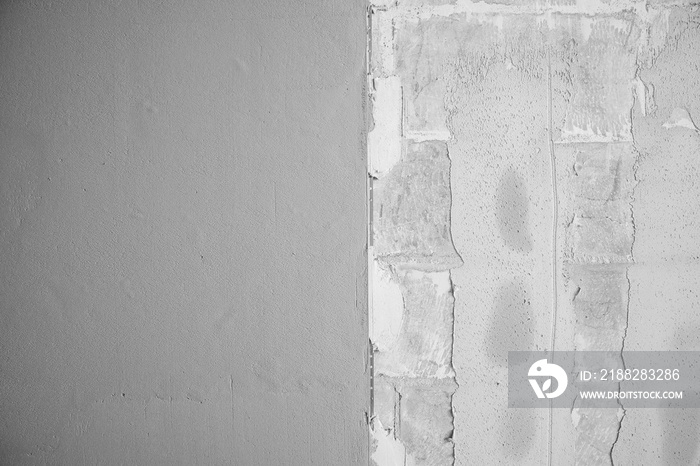 Background gray wall with applied gypsum plaster to smooth surface. Apartment repair concept