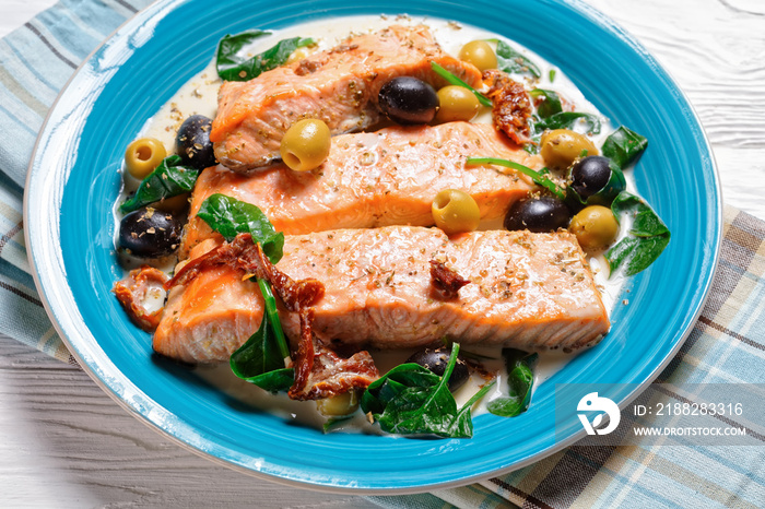 Salmon stew with cream sauce on a plate, top view