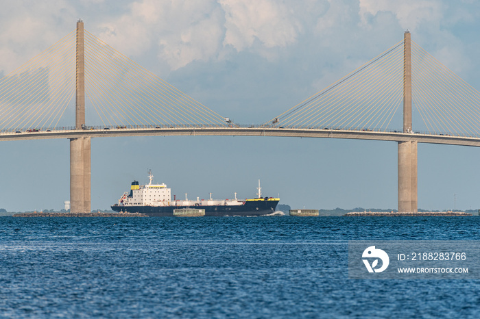 Tanker sailing under bridge