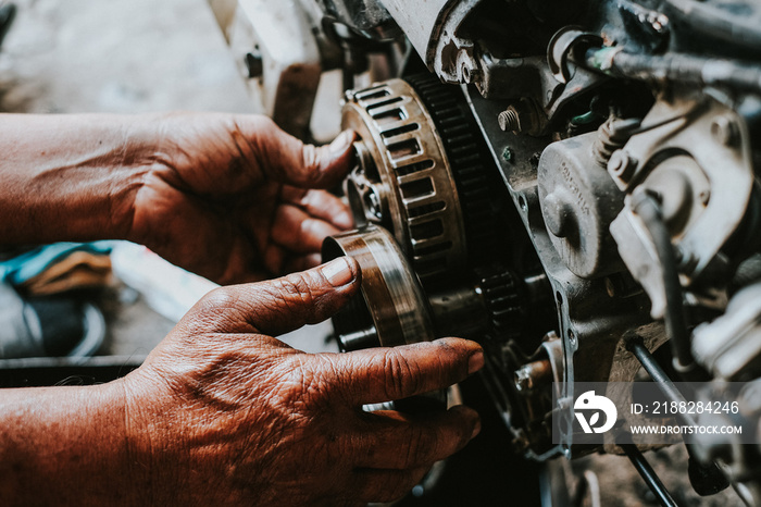 Motorcycle mechanics are assembling the motorcycle engine clutch assembly and maintenance.