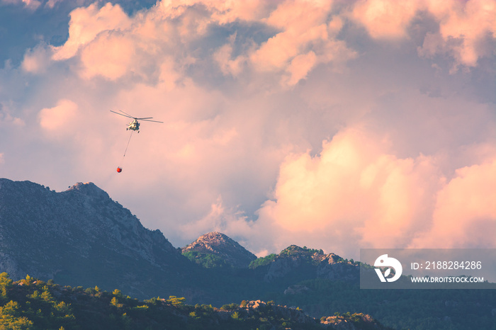 Helicopter extinguish a fire in mountains