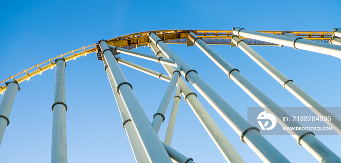 View from below of roller coaster about to drop