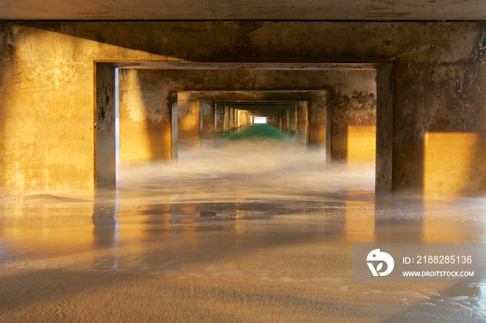 Underneath Hanalei pier on the Hawaiian island of Kauai early in the morning