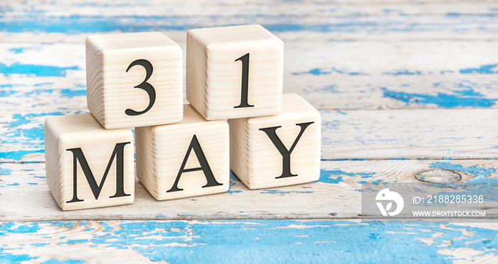 May 31st. Wooden cubes with date of 31 May on old blue wooden background.