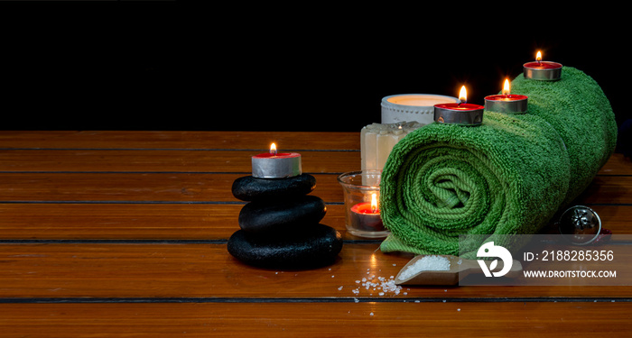 Concept of spa with massage stone, towel and candles