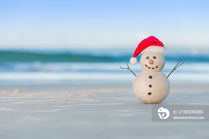 Christmas Sandy Snowman on a beautiful sand beach - Christmas symbol of countries where the weather is always warm