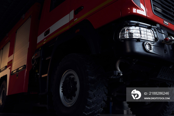 Close up view of red modern fire truck. Front part of vehicle