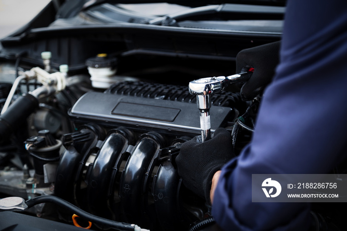 Automobile mechanic repairman hands repairing a car engine automotive workshop with a wrench, car service and maintenance , Repair service