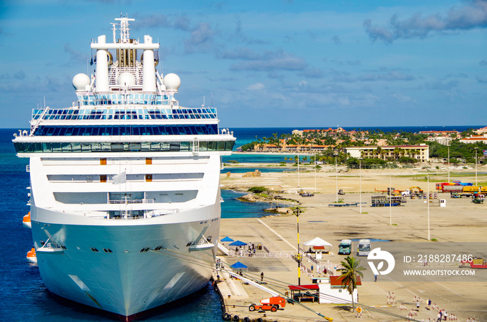 Modern cruiseship or cruise ship liner Coral Princess Cruises in port of Oranjestad, Aruba during Caribbean cruises on sunny day with blue sky and panoramic ocean seascape dream vacation to tropics