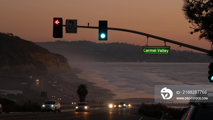 Traffic lights on pacific coast highway 1, Torrey Pines state beach, Del Mar, San Diego, California USA. Coastal road trip vacations. Roadtrip on freeway 101 along ocean. Cars in evening twilight dusk