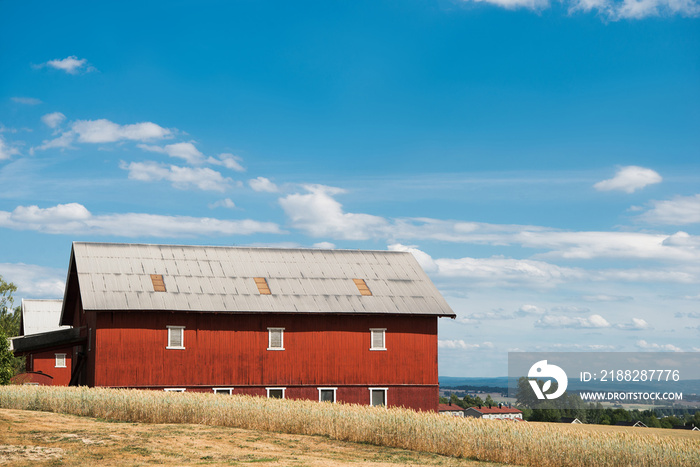 red farm building under blue cloudy sky, Hamar, Hedmark, Norway