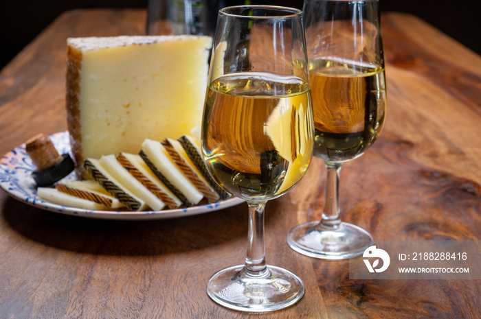 Spanish fino sherry wine from Andalusia and pieces of different sheep hard manchego cheeses made in La Mancha, Spain. Wine and cheese pairing