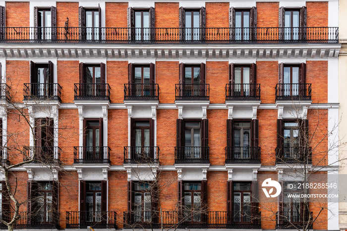 Elevation View of Old Luxury Residential Building with Brick Facade and Balconies. Salamanca District in Madrid. Real Estate market, property and maintenance concepts