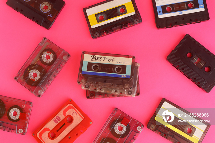 Retro audio cassette tape from the 80s and 90s on a red background.