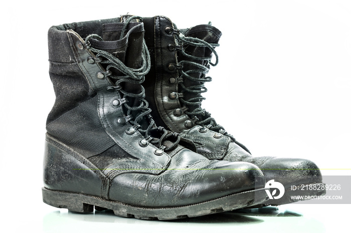 Black old combat military boots isolated on white background