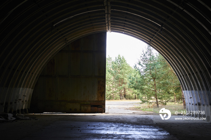 Interior of abandoned old military hangar for storage and maintenance of fighter jets and other military aircraft