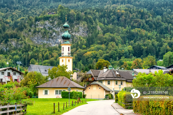 Alpine village St. Gilgen with Parish Church of Saint Egidius, mountains on background, Austria.