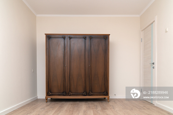 Old wooden wardrobe in a renovated living room