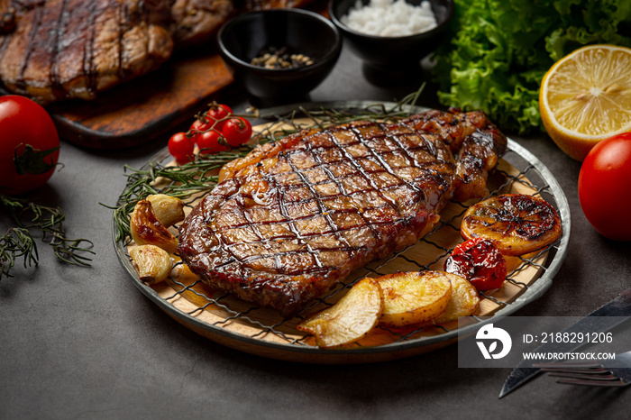 Grilled beef steak steak on the dark background.