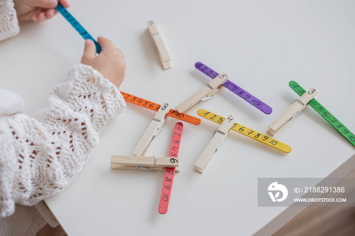 Using craft sticks for learning maths, numbers in early childhood. Home education, addition fun activities, easy and effective education.