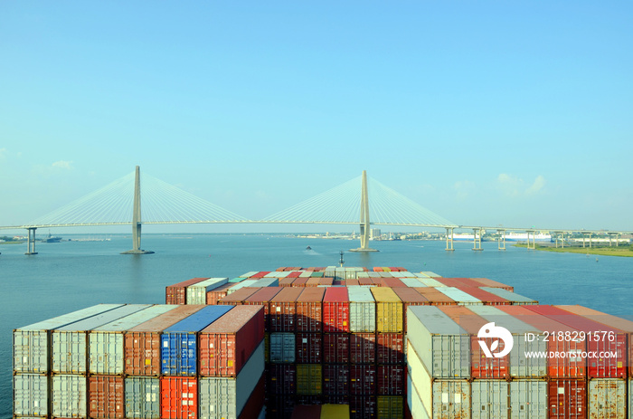 Container ship approaching to the  Arthur Ravenel Jr. Bridge in Charleston, South Caroline.