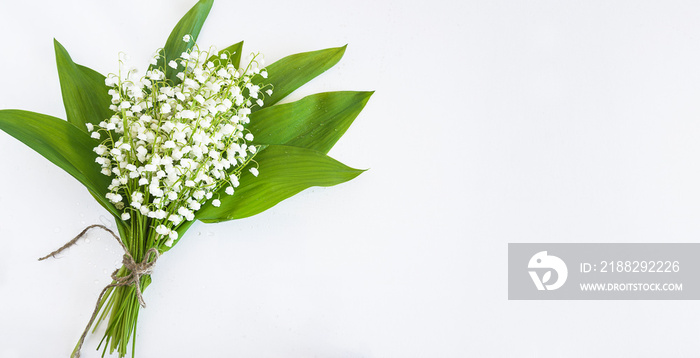 Beautiful bouquet of lilies of the valley on white background. Space for text, flat lay