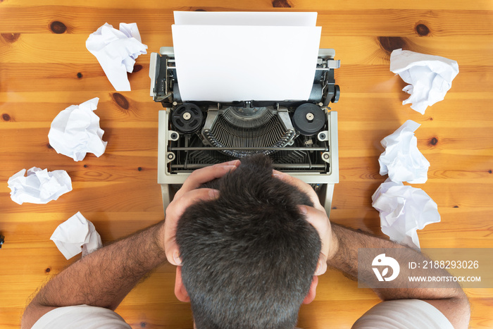 Writer’s block. Typewriter and crumpled paper on work desk. Creative process concept