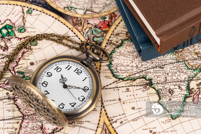 Vintage pocket watch clock on ancient map background with books