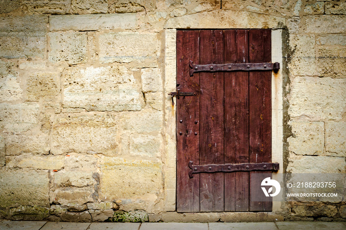 Medieval castle wooden door with massive iron hinges.